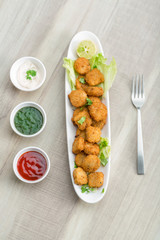 Button cutlets with sauce and green chutney