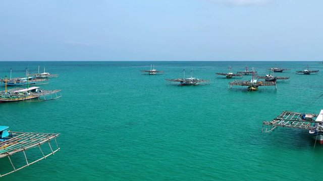 Aerial view of drone fliying over fishing boat at Tanjung Binga fishing Village in Belitung Island Indonesia. Fishing Boat on Clear water.