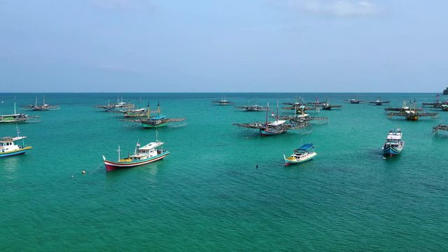 Aerial view of drone fliying over fishing boat at Tanjung Binga fishing Village in Belitung Island Indonesia. Fishing Boat on Clear water.