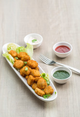 Button cutlets with sauce and green chutney