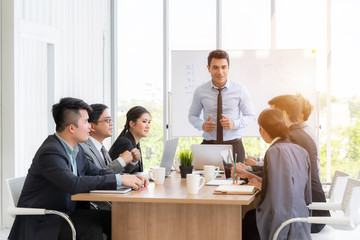 Businesspeople discussing together in conference room during meeting at office.