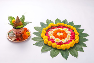 Copper Kalash with coconut , leaf and floral decoration on a white background. essential in hindu puja.