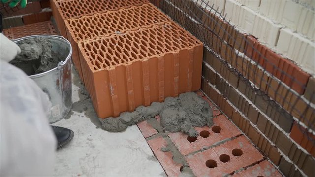 warm pottery and ceramic brickwork , reinforcing belt formwork. Building a house from ceramic blocks.