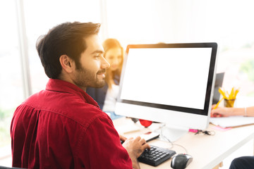 Marketing team. Group of young modern people in smart casual wear discussing something while working in the creative office.