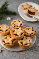 Delicious fruit mince tarts for Christmas dinner. Grey background, selective focus