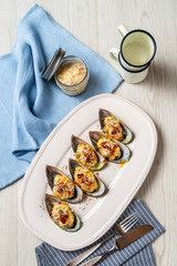 Overhead of dinner table. Assorted delicious grilled fresh mussel baked with cheese. Bbq party concept