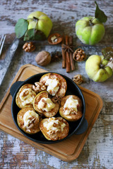Fototapeta na wymiar Baked quince with sweet cheese, cinnamon and nuts. Healthy dessert. Keto diet.