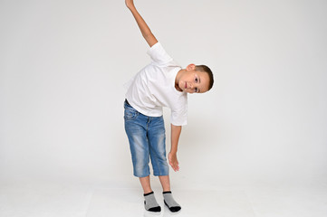 Full-length portrait on a white background of a cute boy child with Vitiligo disease - a violation...