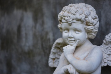 Fototapeta na wymiar Stucco doll, Cupid, the god of conveying love in Western beliefs