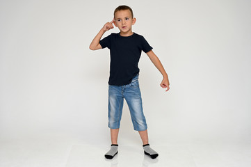 Full-length portrait on a white background of a cute boy child with Vitiligo disease - a violation...