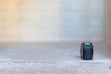 Laser level. Laying tiles. Construction of houses and apartments.