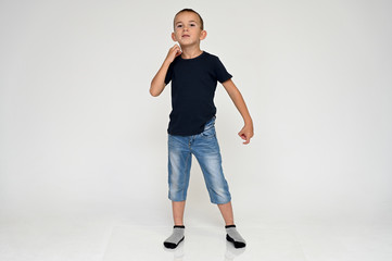 Full-length portrait on a white background of a cute boy child with Vitiligo disease - a violation...