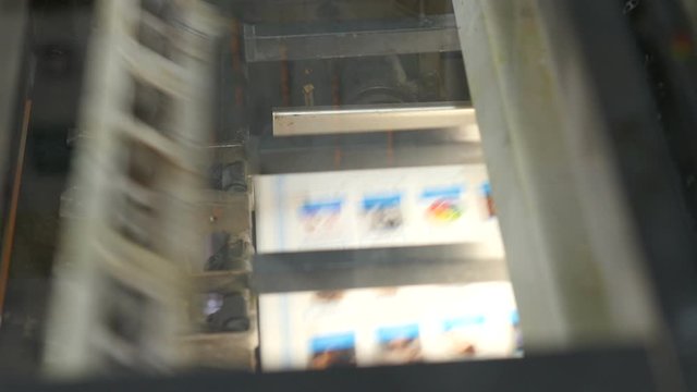 Printing press machinery working at high speed in a large factory