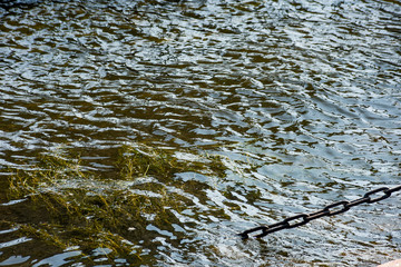 Rust metal chain goes under water