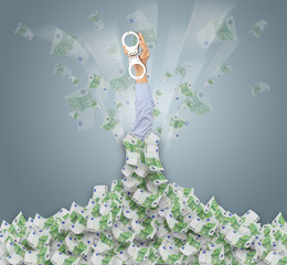 Human hand buried in euro pile and trying to break out