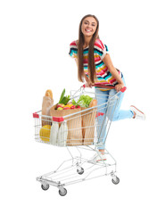 Young woman with full shopping cart on white background © New Africa