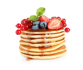 Stack of delicious pancakes with fresh berries and syrup on white background