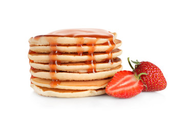 Stack of delicious pancakes with fresh strawberry and syrup on white background