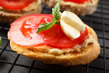Tasty fresh tomato bruschettas on cooling rack