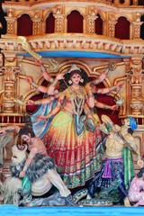 Obraz premium Goddess Durga idol at decorated Durga Puja pandal, shot at colored light, at Kolkata, West Bengal, India. Durga Puja is biggest religious festival of Hinduism and is now celebrated worldwide.