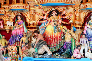 Goddess Durga idol at decorated Durga Puja pandal, shot at colored light, at Kolkata, West Bengal, India. Durga Puja is biggest religious festival of Hinduism and is now celebrated worldwide.