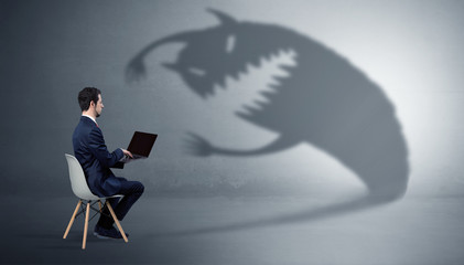 Young businessman staying and negotiate with a monster shadow
