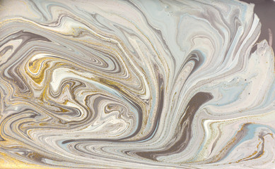 Gray marble pattern with golden glitter. Stone ripple texture.