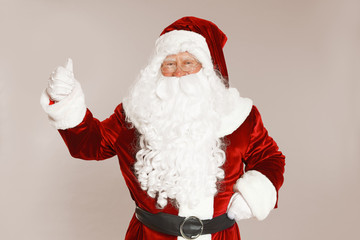Happy authentic Santa Claus on grey background