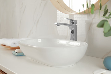 Stylish bathroom interior with vessel sink and decor elements