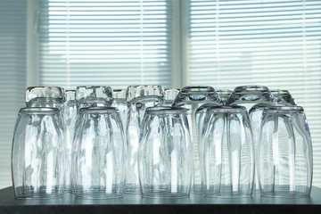 Empty glasses on grey table against blurred background