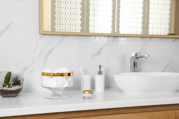 Jar with cotton pads on bathroom countertop