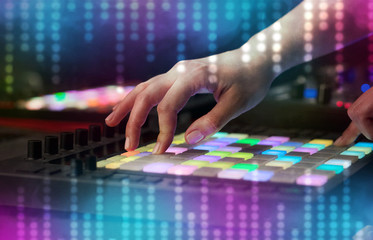 Fototapeta premium Hand mixing music on dj controller with social media concept icons
