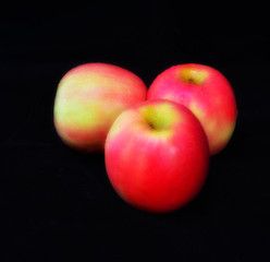 Red apples and black ground