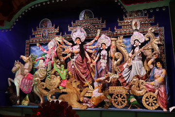 Goddess Durga idol at decorated Durga Puja pandal, shot at colored light, at Kolkata, West Bengal, India. Durga Puja is biggest religious festival of Hinduism and is now celebrated worldwide.