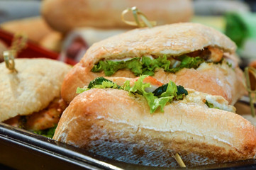Close up. Sandwiches with chicken, salad and vegetables. Snacks in the park at the festival.