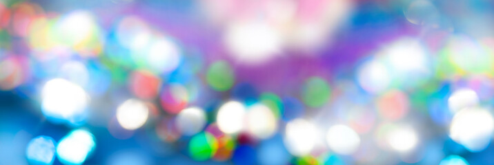 Fototapeta premium Blue colorful bokeh background wide banner. Christmas invitation or phone wallpaper