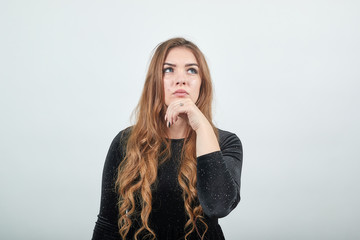 girl brown haired in black dress over isolated white background shows emotions