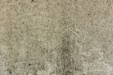 Texture of a concrete wall with cracks and scratches which can be used as a background