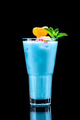 classic blue hawaii cocktail with reflection on dark background