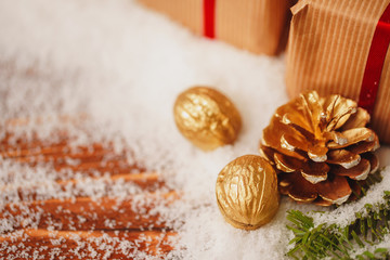 Decorated present on snowy wooden table close up