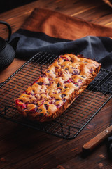 Fresh moist homemade delicious raspberry cake on black cooling rack