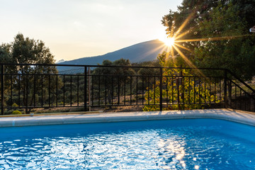 Pool with sun reflection in the water at sunset
