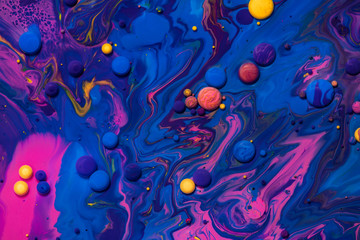 Fototapeta Acrylic paint balls abstract texture. Pink, blue and yellow liquids mix. Creative multicolor background. Bright colors fluid, flowing wallpaper design. Mixed pigments blue backdrop. obraz