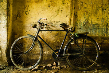 Fototapeta na wymiar Old english bike in a town alley, Kochi, Kerala, India