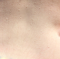 Fototapeta premium Human skin with drops of water as an abstract background