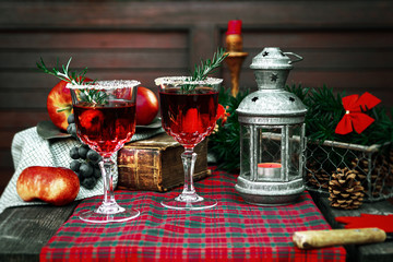 Christmas still life , two glass with red raspberry beverage decorated with rosemary , vintage old fashion style.