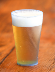 Glass with beer on a wooden background