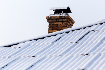 White snow on the roof of the house as an abstract background