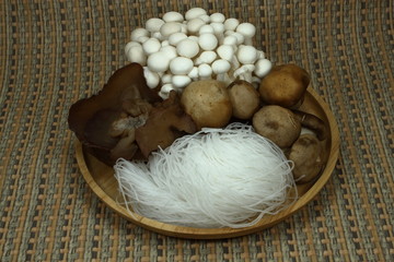 Glass noodle (vermicelli) and multiple kind of mushroom on the plate. Ingredient for fried vegetarian menu. Mix mushroom.