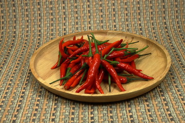 Fresh organic red chilly on the wood plate. Main ingredient in Thailand.